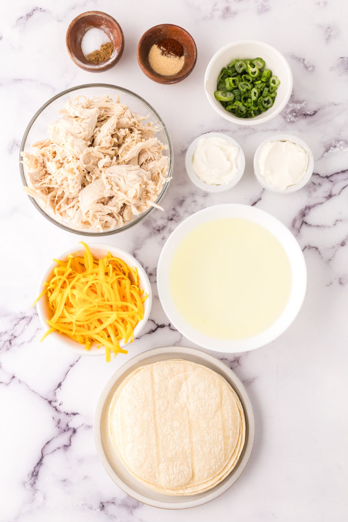Ingredients for leftover turkey taquitos partitioned into bowls.