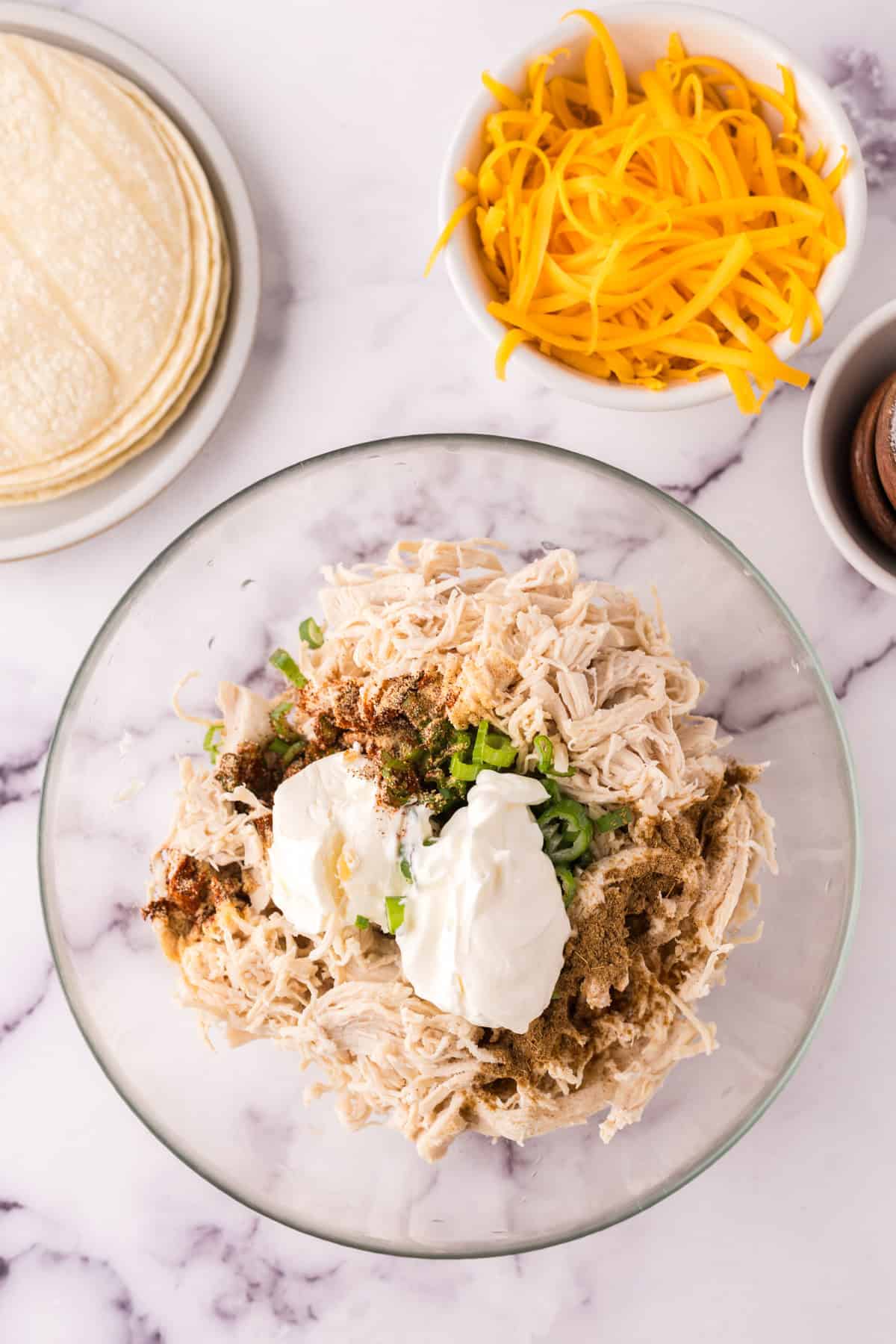 Mixing ingredients in a bowl for turkey taquitos