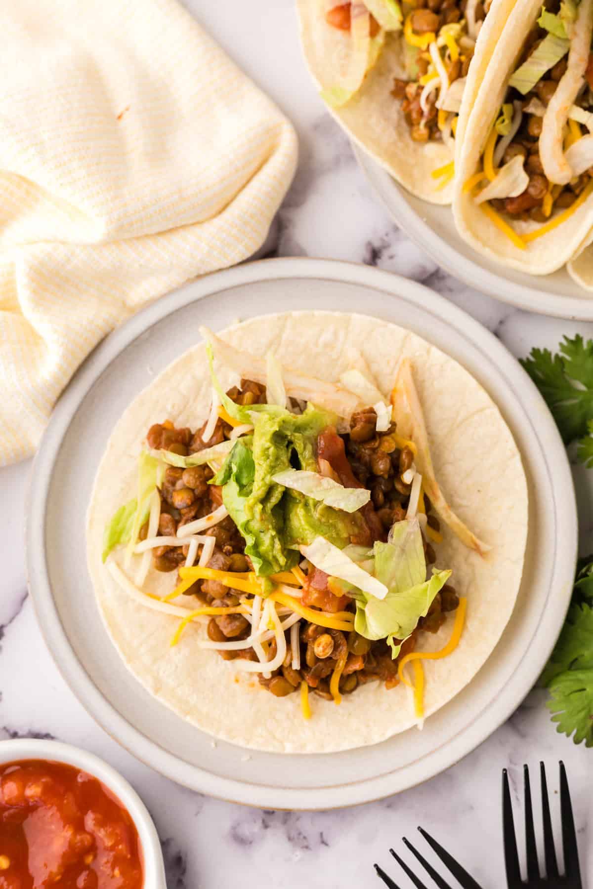open tortilla with lentil tacos inside.