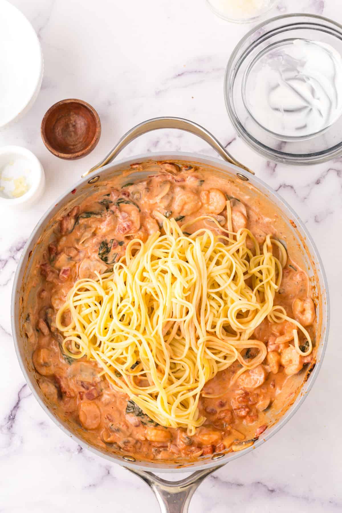 linguini rosa with shrimp in a large pot in progress.