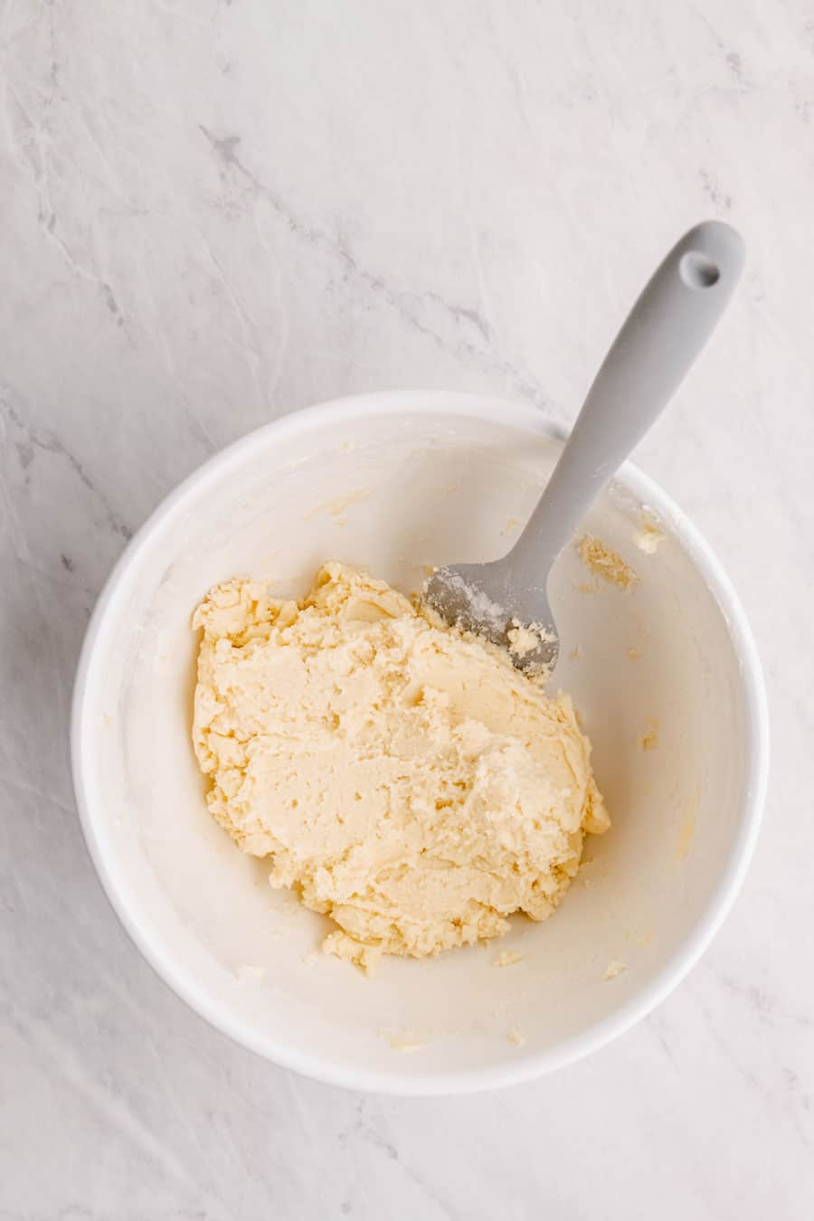 Mixing bowl in the process of making melt away cookie dough.