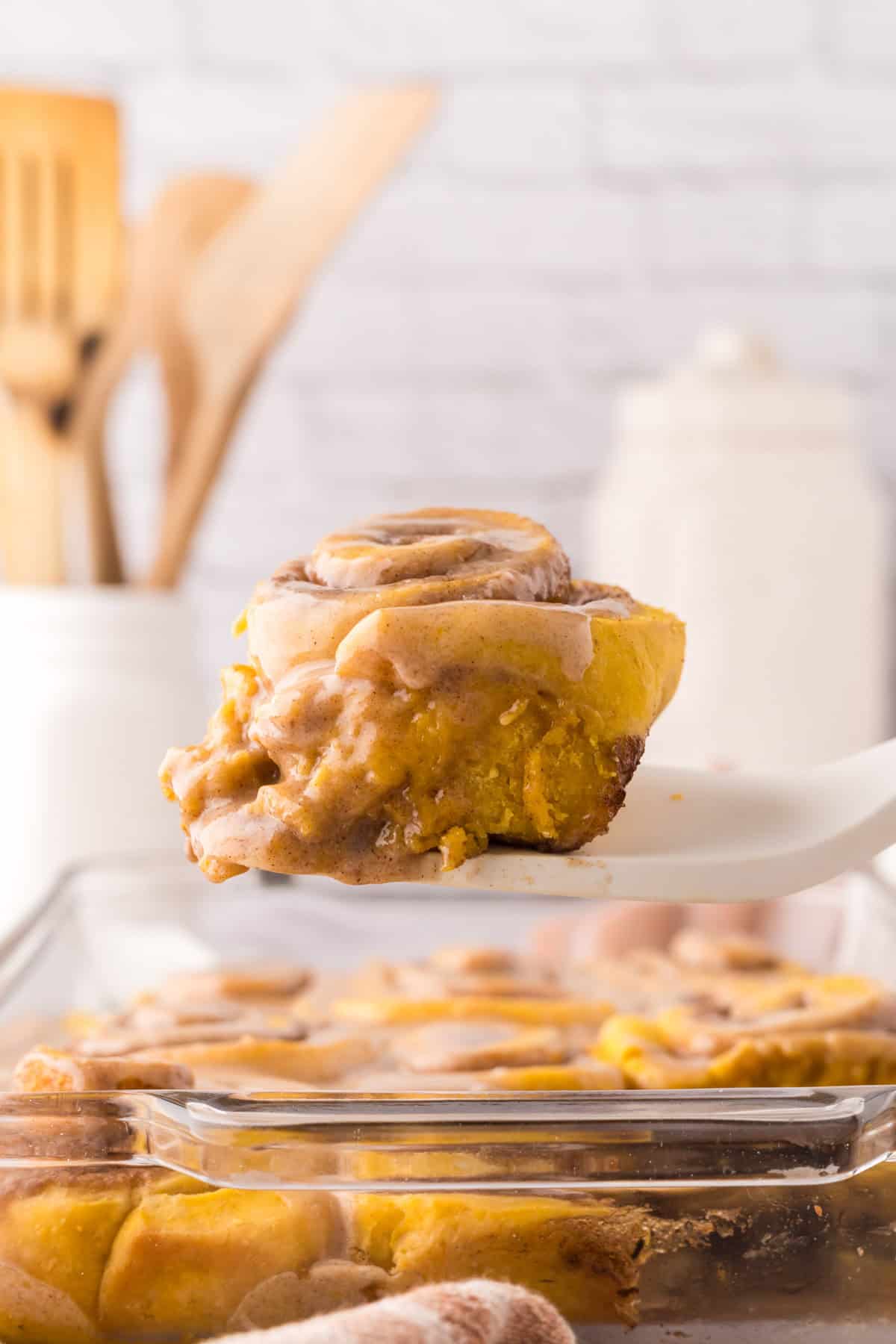 pumpkin cinnamon roll recipe on a spatula.
