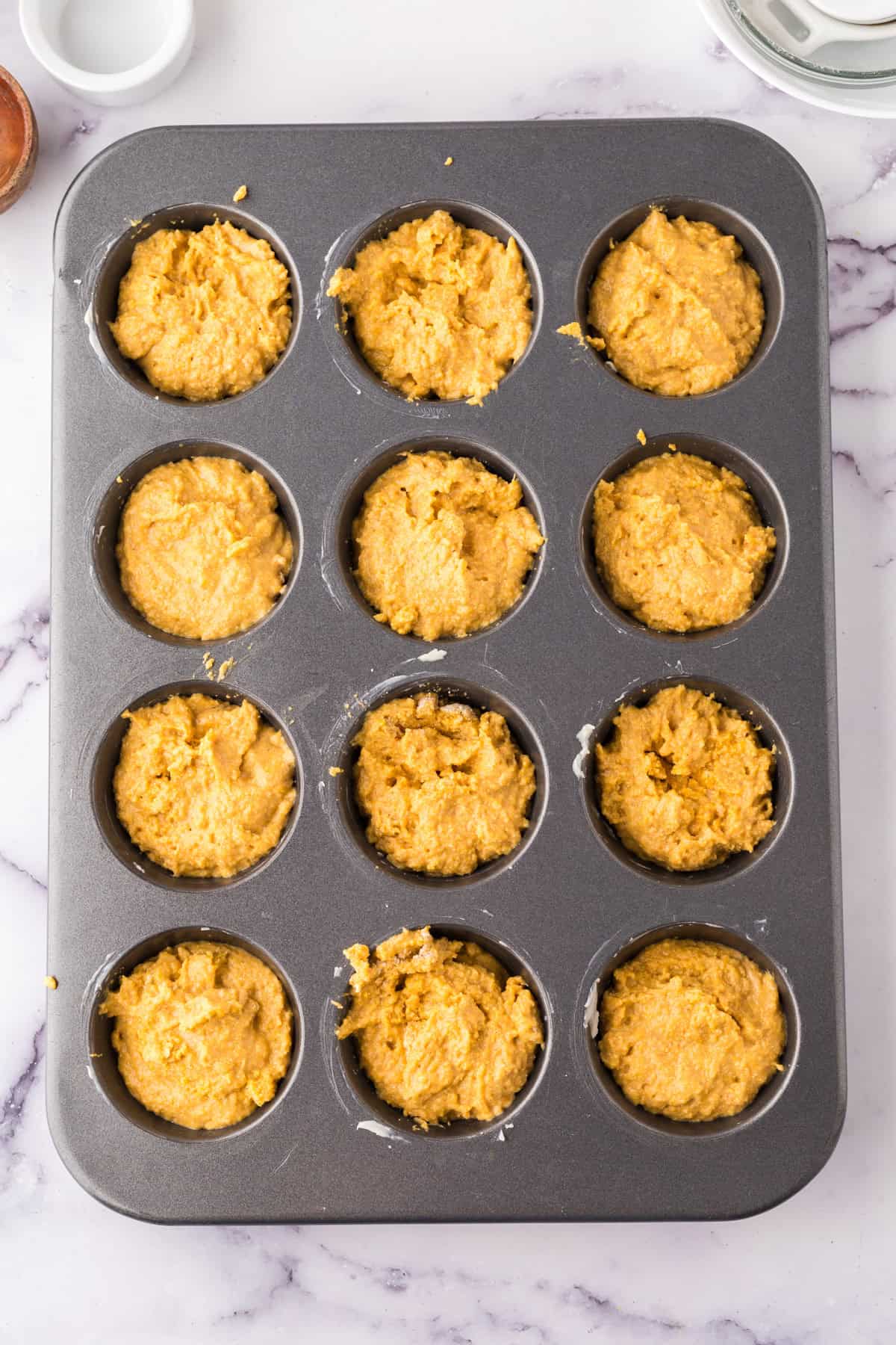 pumpkin cornbread muffins dough before going in the oven.