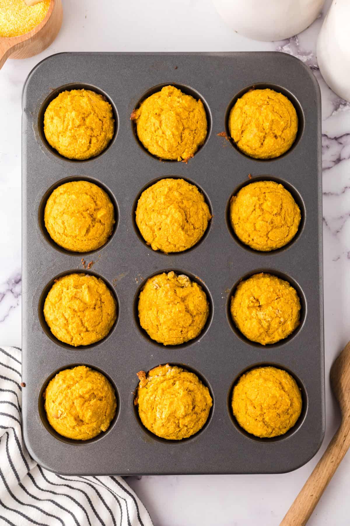 pumpkin cornbread muffins baked into the tin.