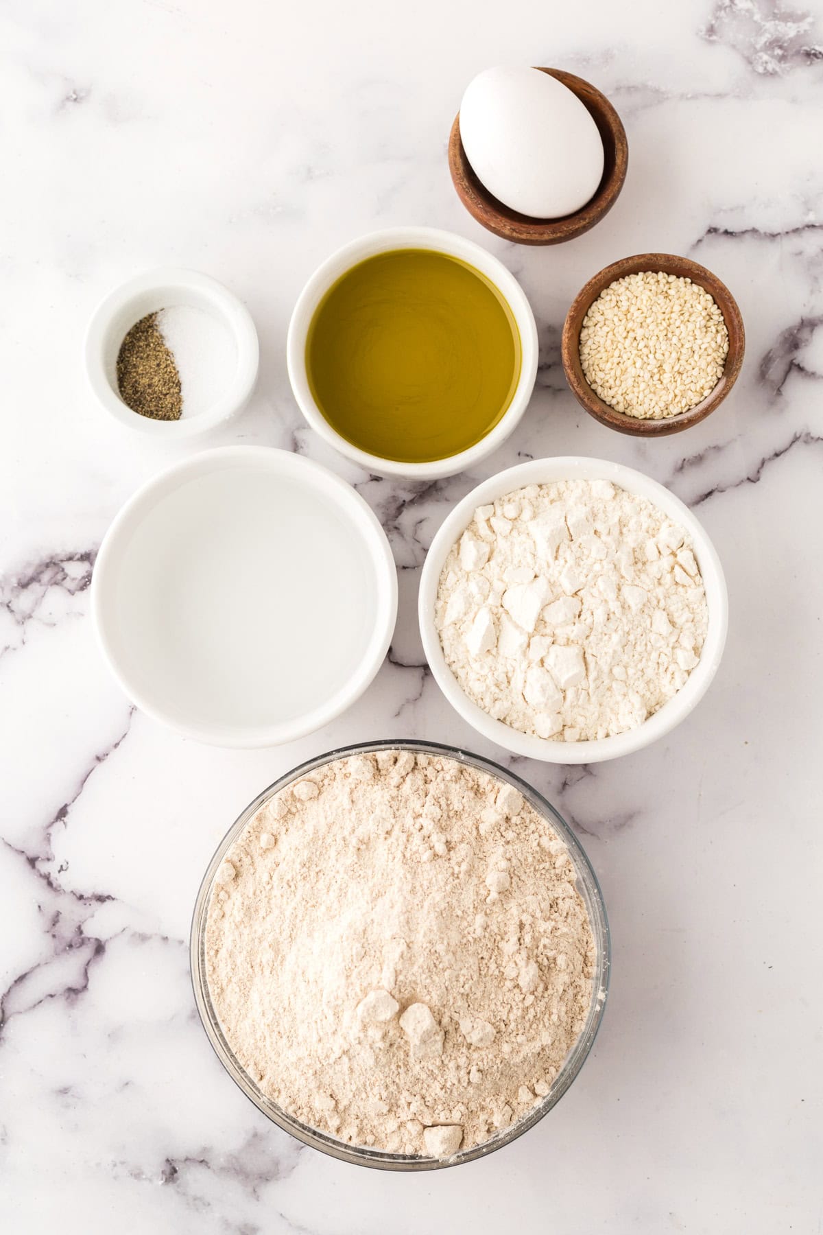 portion bowls each with raw ingredients to make simple lavish crackers.