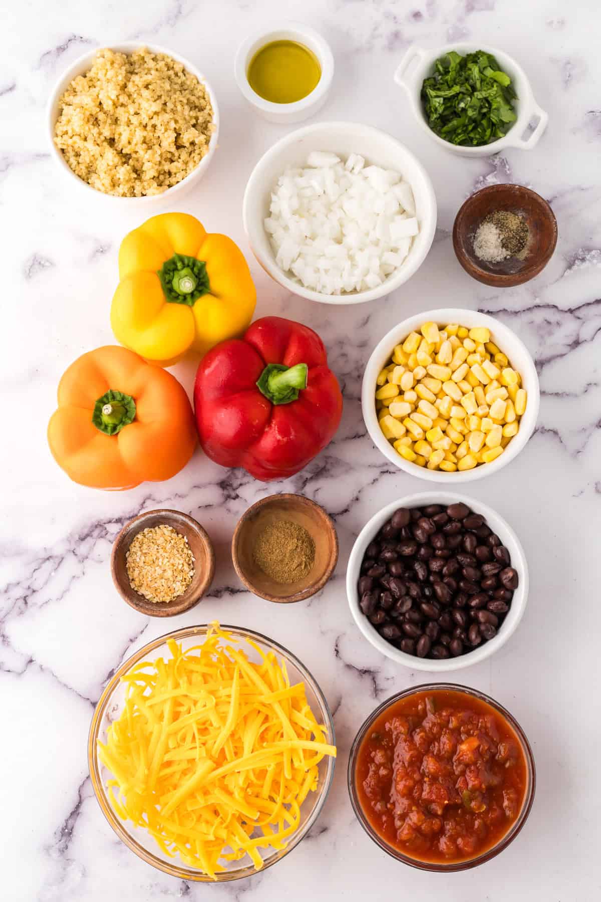 portion bowls each with raw ingredients to make slow cooker stuffed bell peppers.