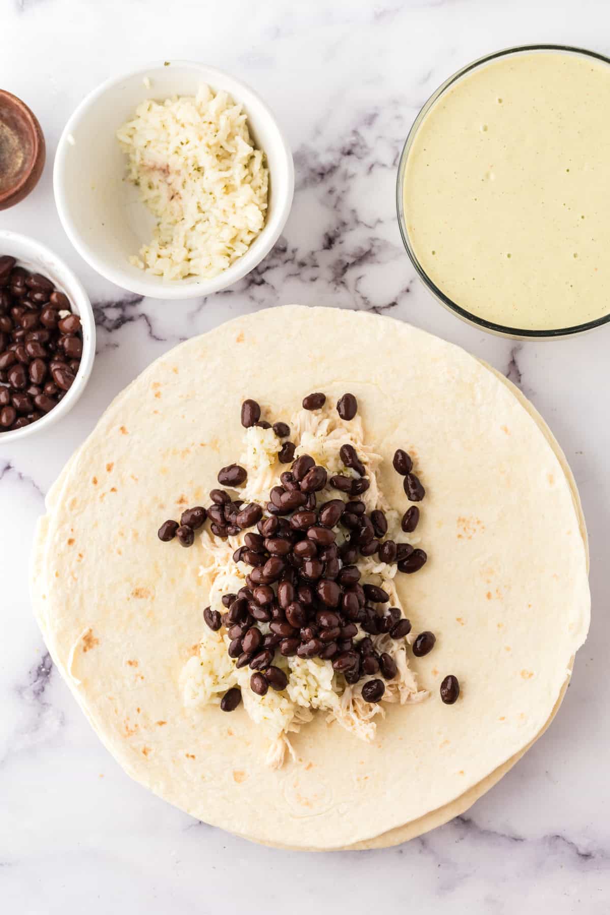 the process of making tomatillo ranch burrito roll ups in the shell.
