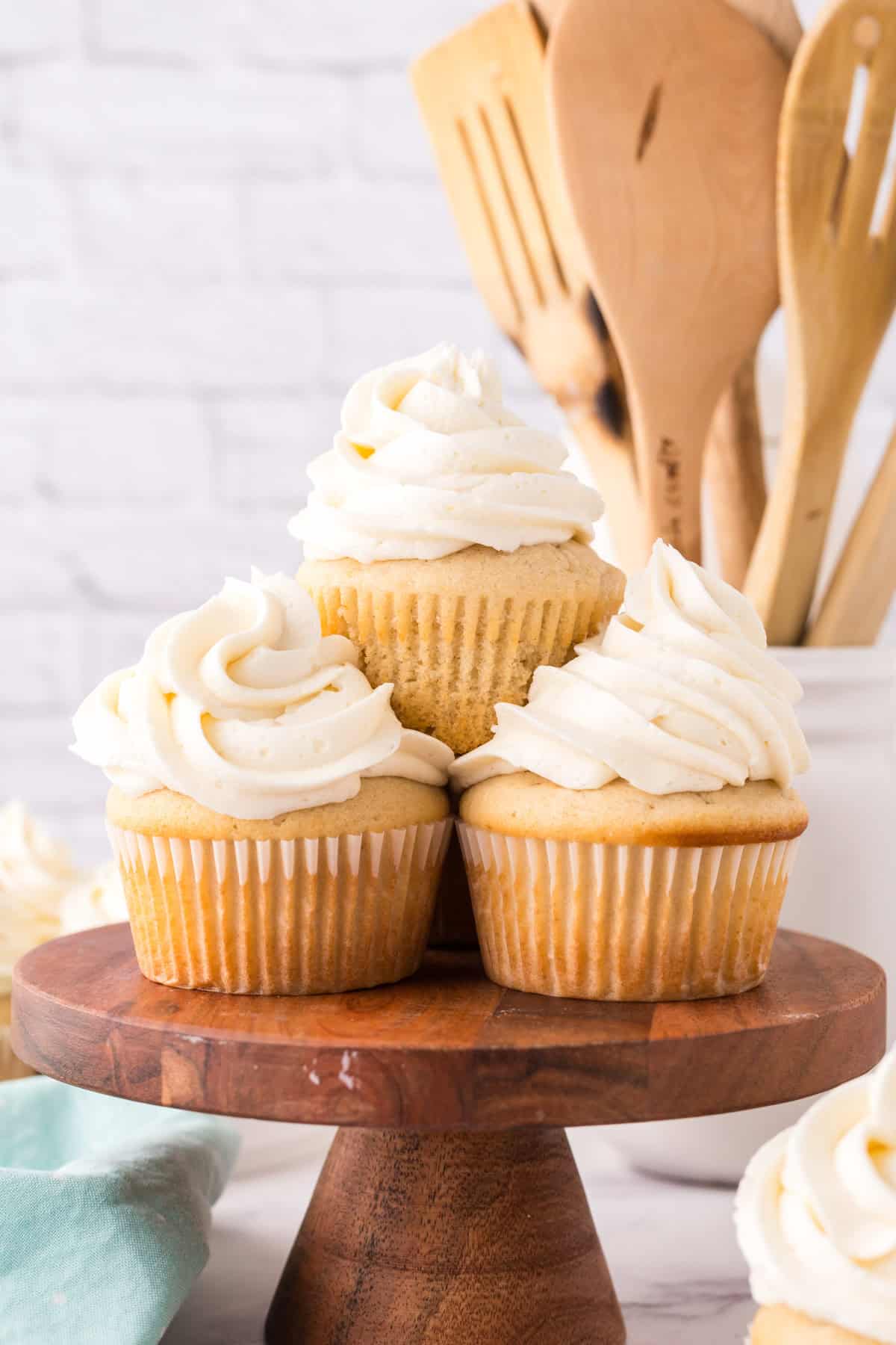Copycat vanilla cupcakes with vanilla frosting on top in a swirl.