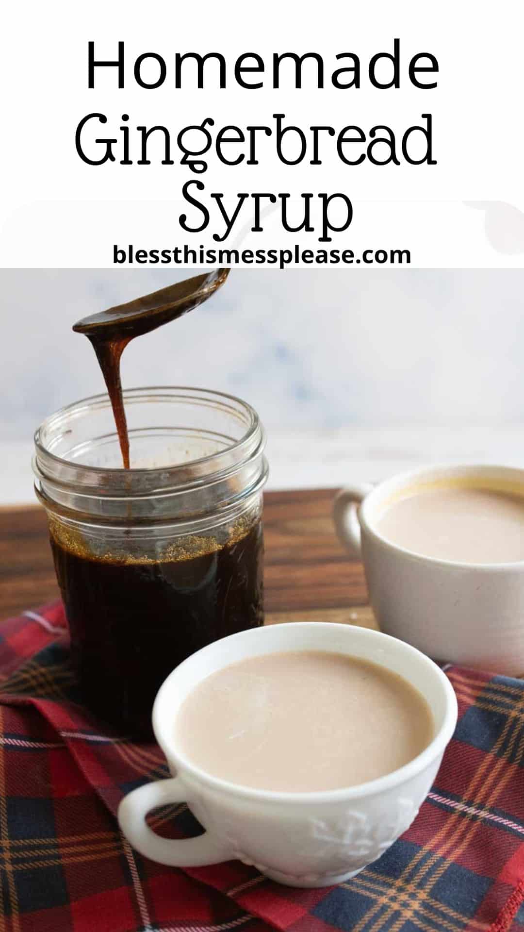 A jar of homemade gingerbread syrup sits on a wooden surface, with syrup being poured. Two cups of coffee or tea are on a plaid cloth next to it. The text reads Homemade Gingerbread Syrup and