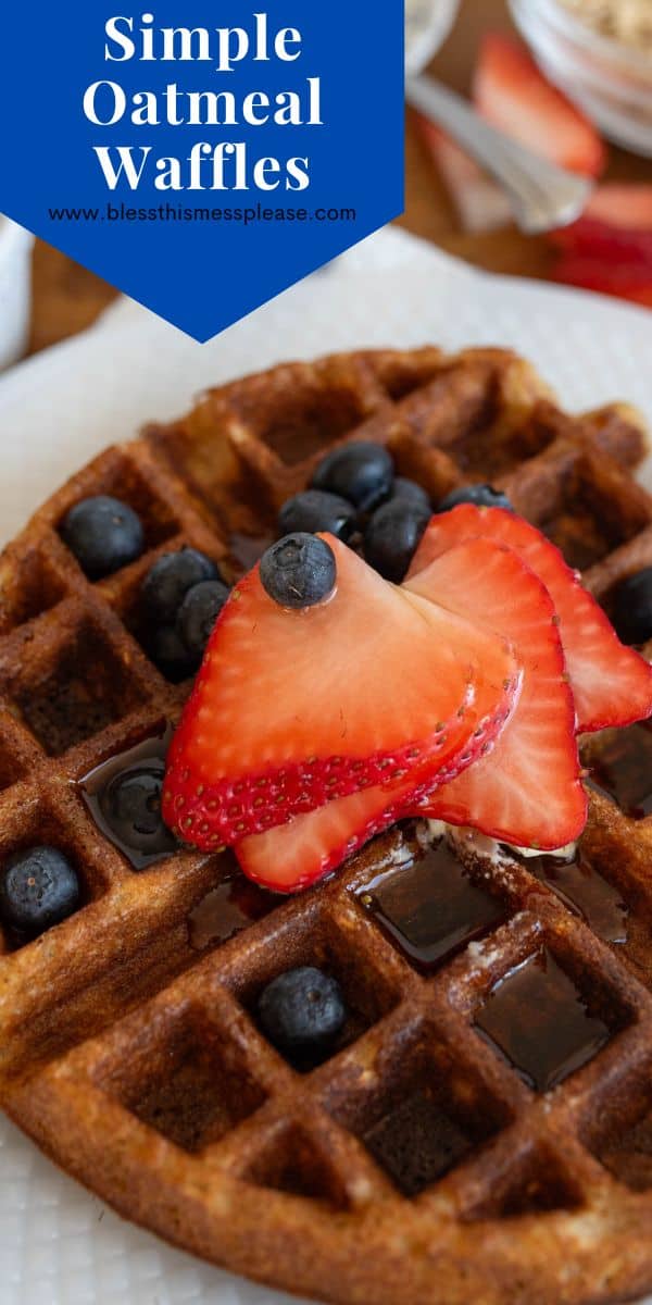 A close-up of a waffle topped with fresh blueberries and sliced strawberries, drizzled with syrup. The waffle sits on a white plate. A blue banner at the top reads Simple Oatmeal Waffles.