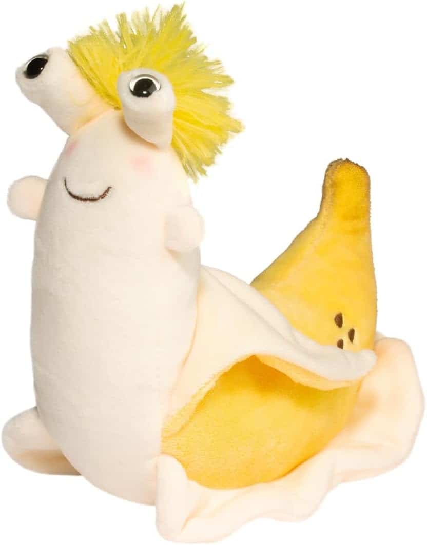 A plush toy shaped like a snail, with a creamy white body, big googly eyes, a yellow tuft of hair, a smiling face, and a shell that looks like a yellow banana with brown spots.