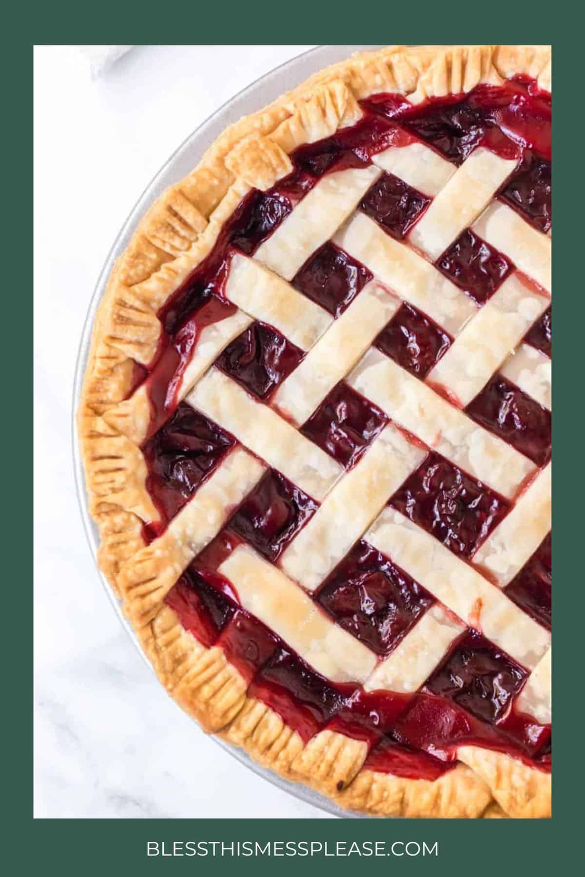 A close-up of a cherry pie with a golden, lattice crust and crimped edges—perfect for christmas pies. The pie is partially shown on a white surface, with the website at the bottom.